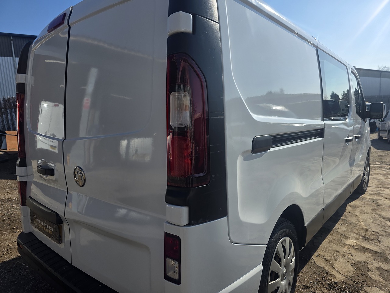 Plain white medium van photographed from the rear three-quarter on our own forecourt