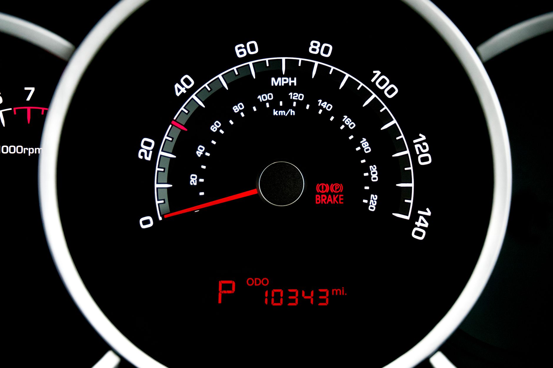 Vehicle instrument cluster reading in miles per hour with a low odometer total showing