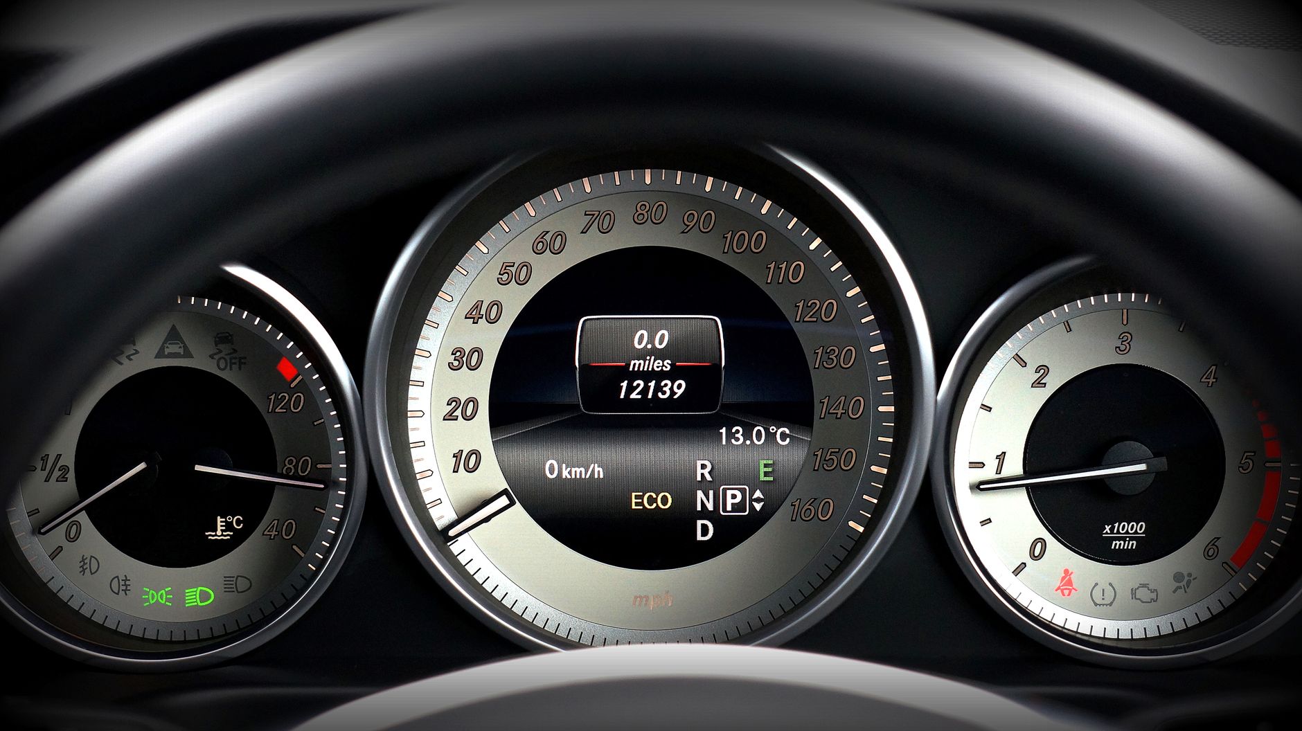 Digital instrument display reading in miles per hour showing a low total mileage figure
