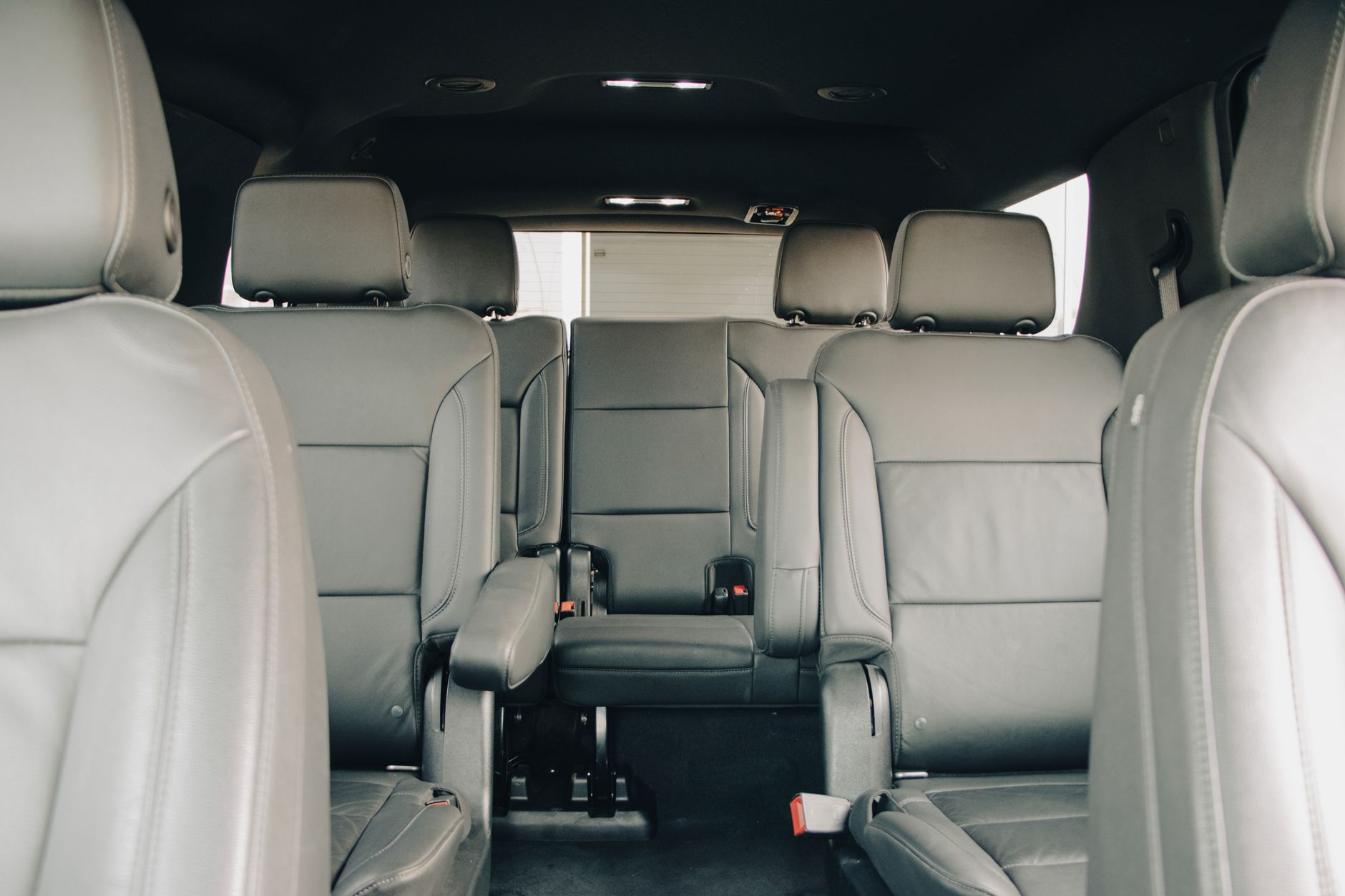 Rows of bench seating inside the passenger area of a crew-cab vehicle