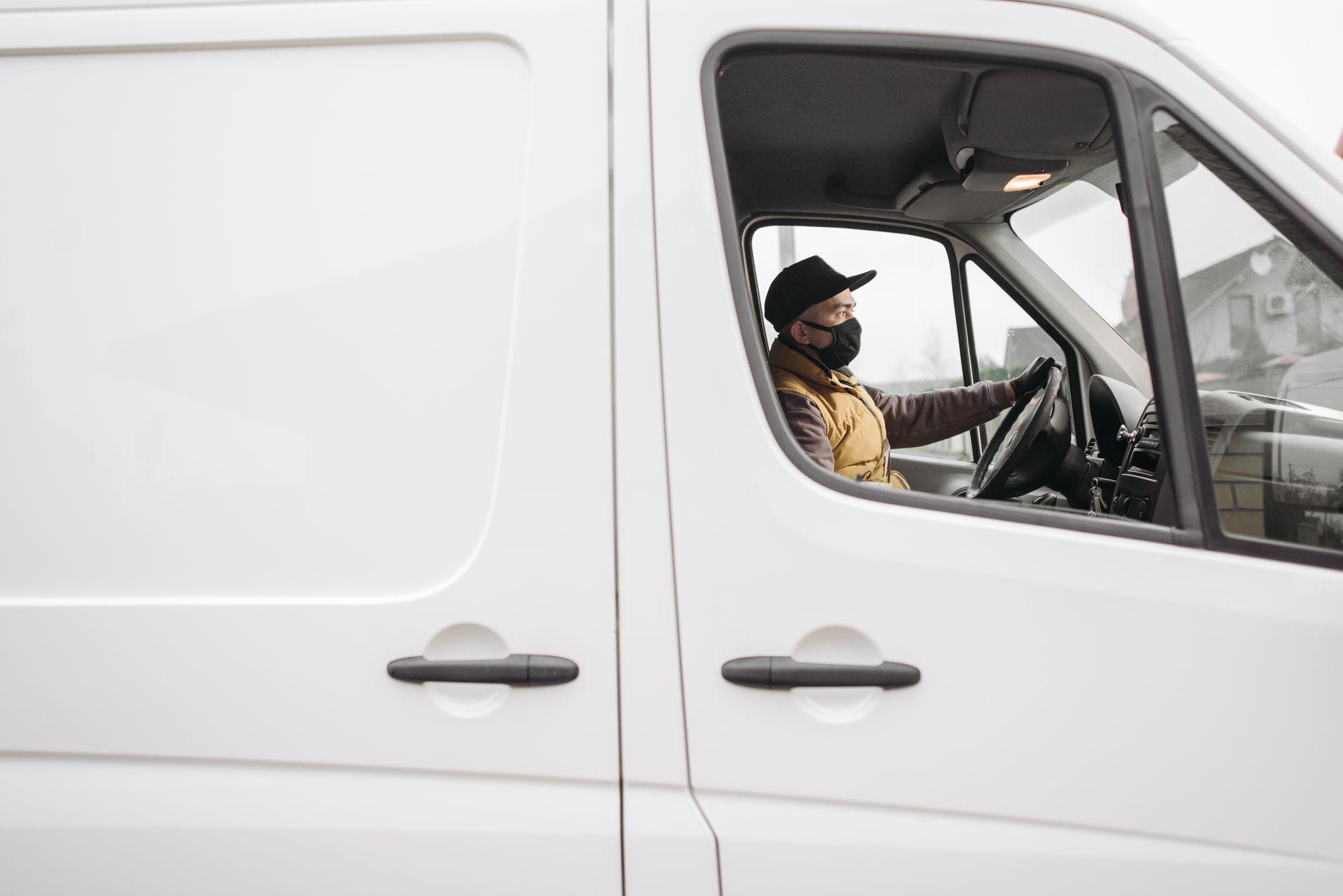 Driver at the wheel of a panel van on a working day
