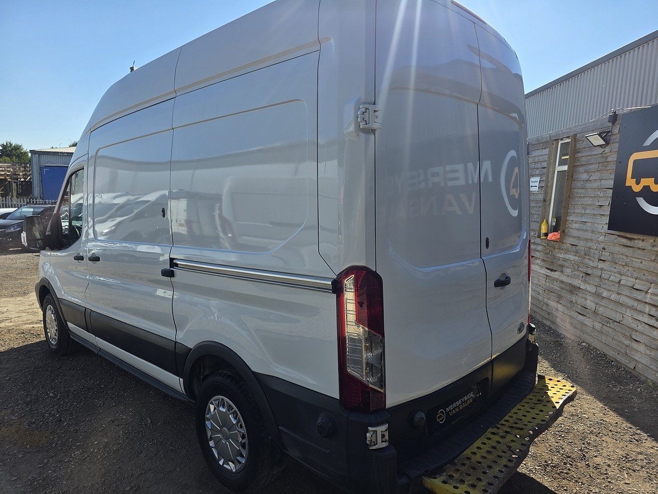 Rear doors open on a full-size Ford Transit panel van at our dealership