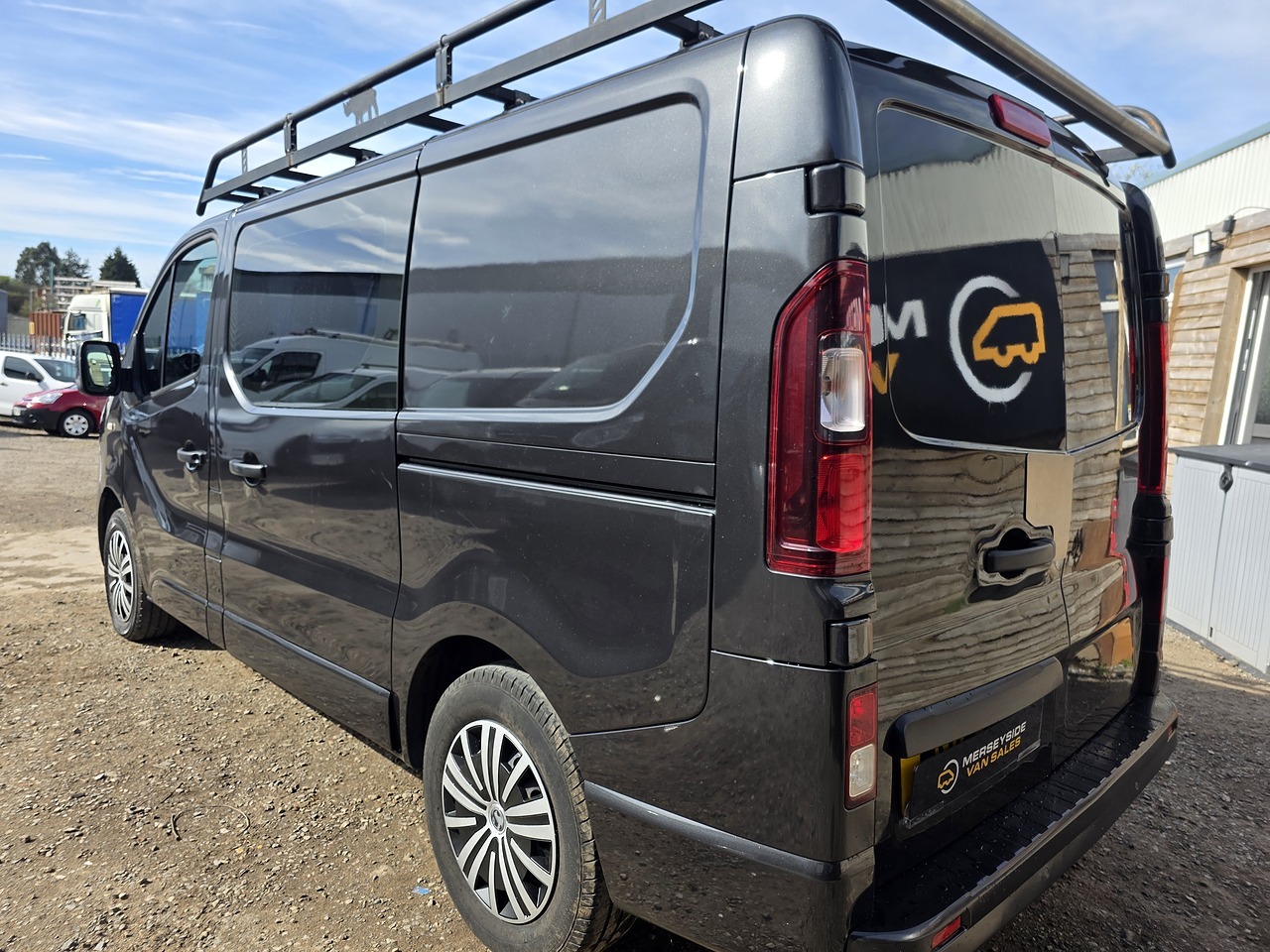 Vauxhall Vivaro in trade specification with a roof rack, photographed on our forecourt