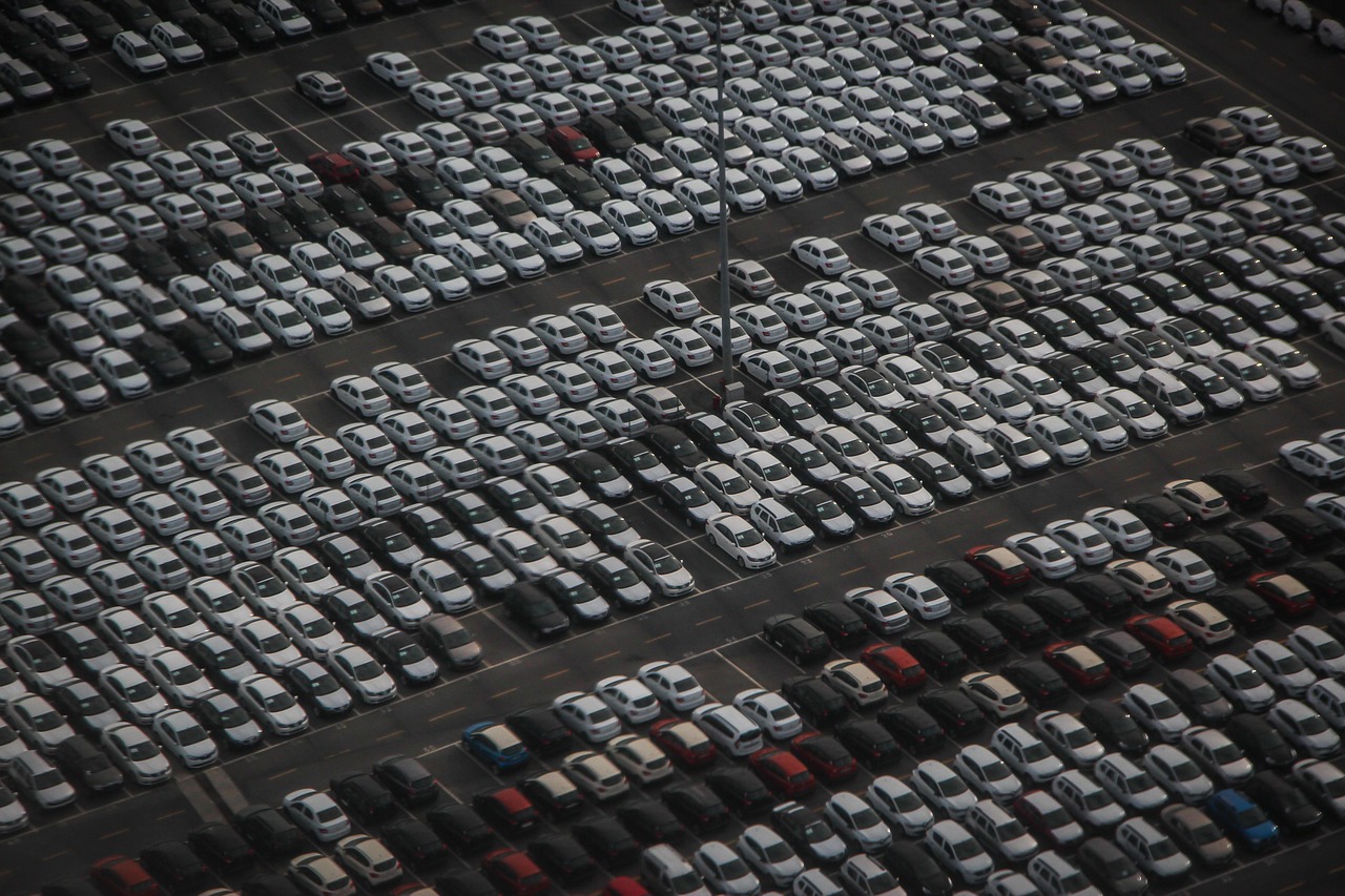 An aerial view of a large storage compound filled with parked vehicles