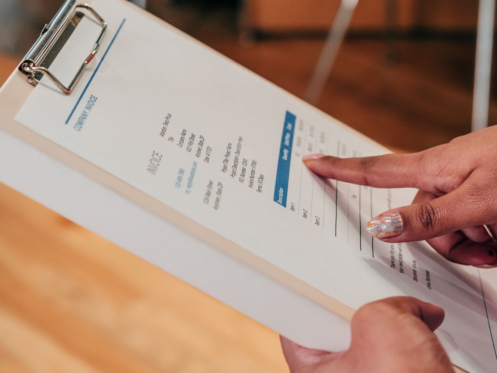Hands holding a printed statement on a clipboard