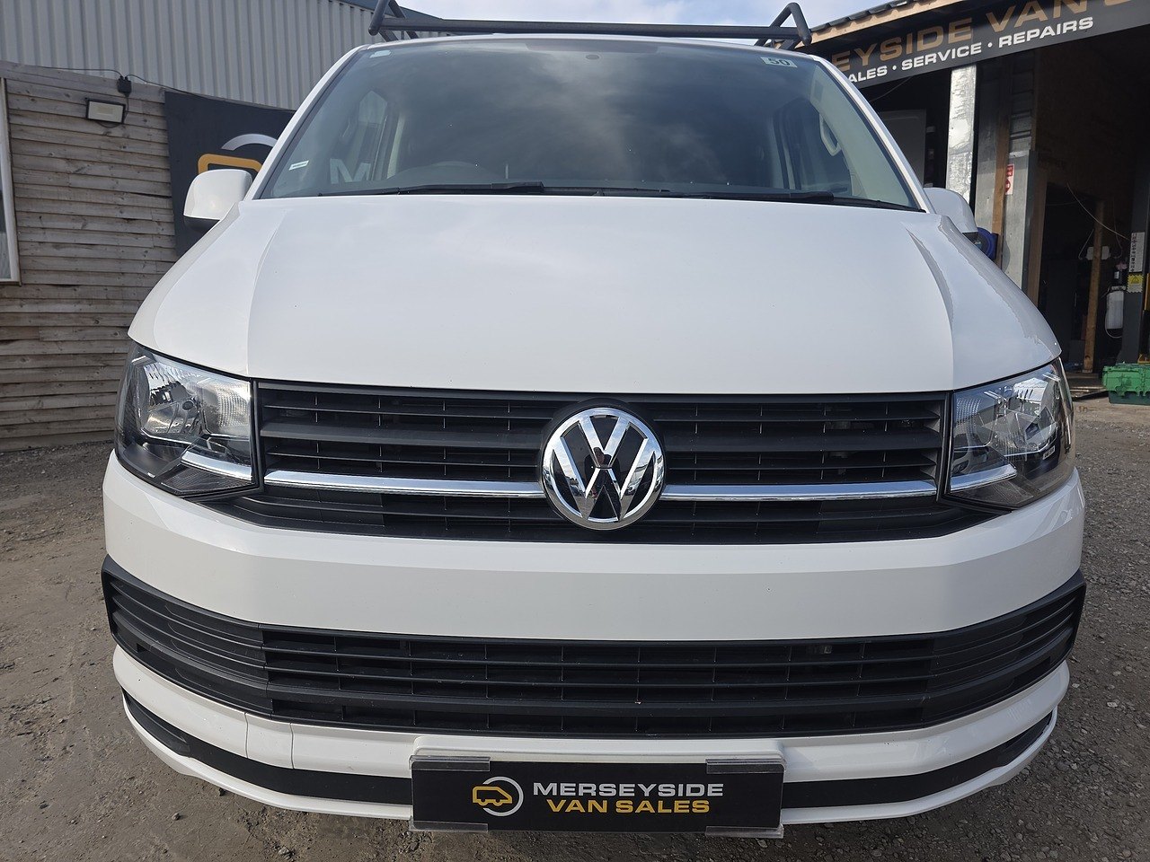 A white Volkswagen Transporter panel van parked on our own forecourt