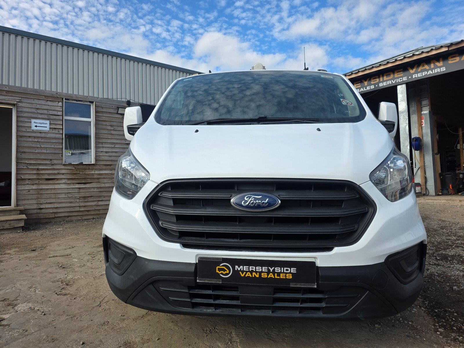 A white Ford Transit Custom photographed head-on at our own premises