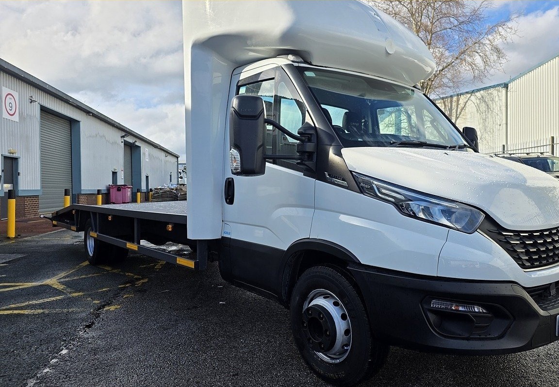 Iveco Daily flatbed chassis cab seen from the side on our yard