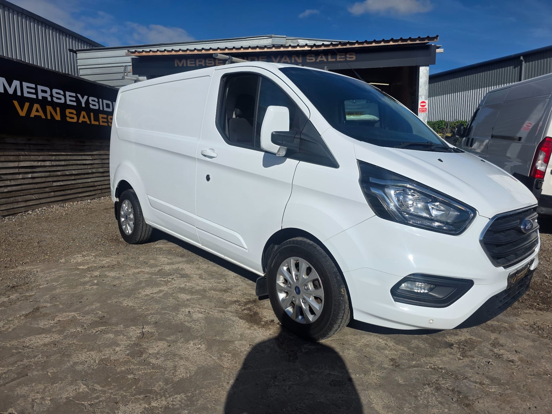 Ford Transit Custom panel van on our forecourt under a clear sky