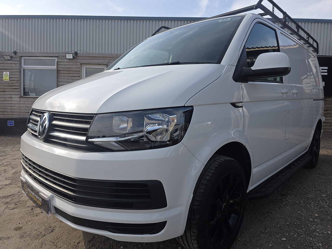 Volkswagen Transporter panel van with a roof rack on our forecourt