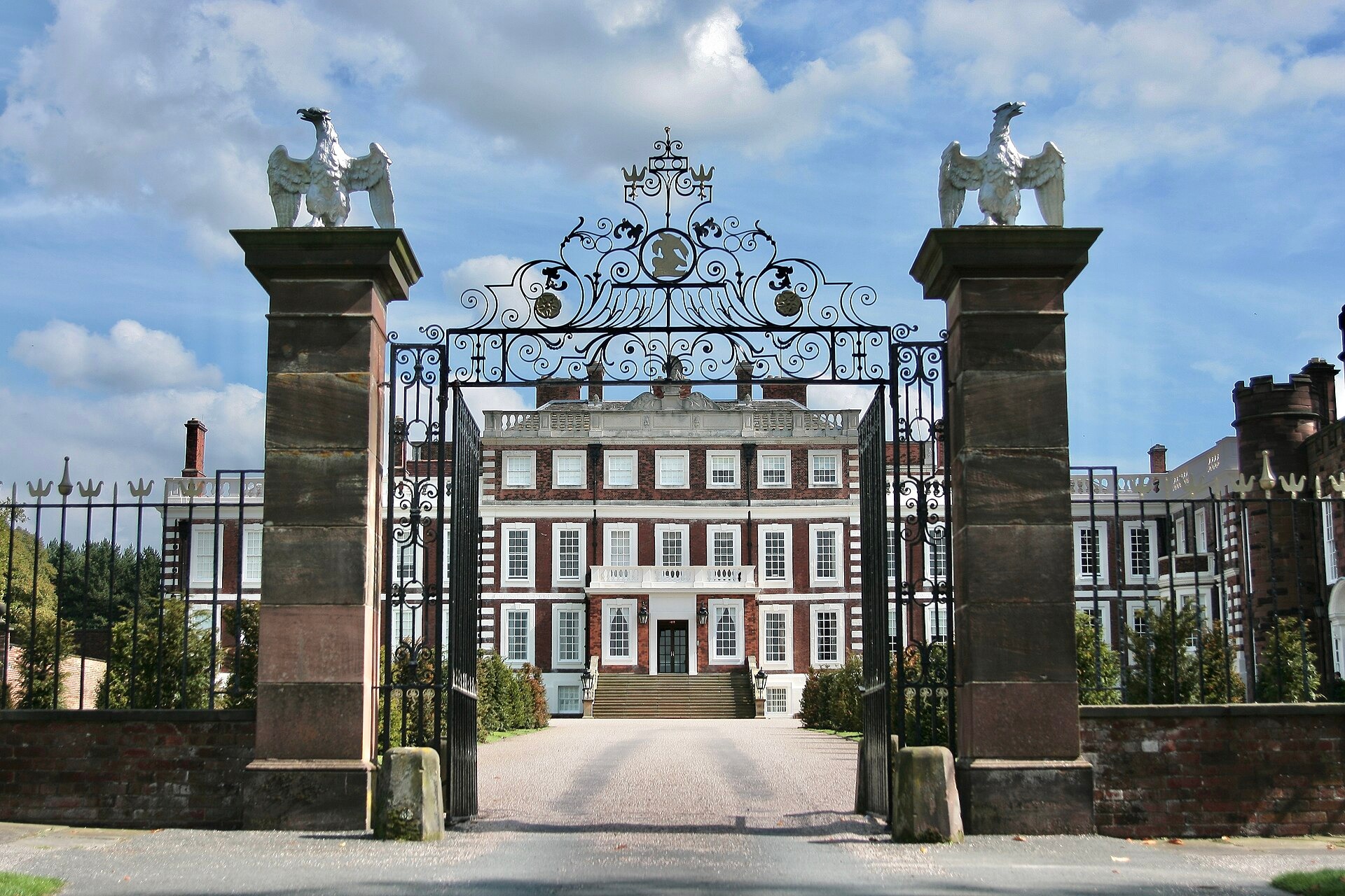Knowsley Hall seen through the wrought iron gates of its main drive