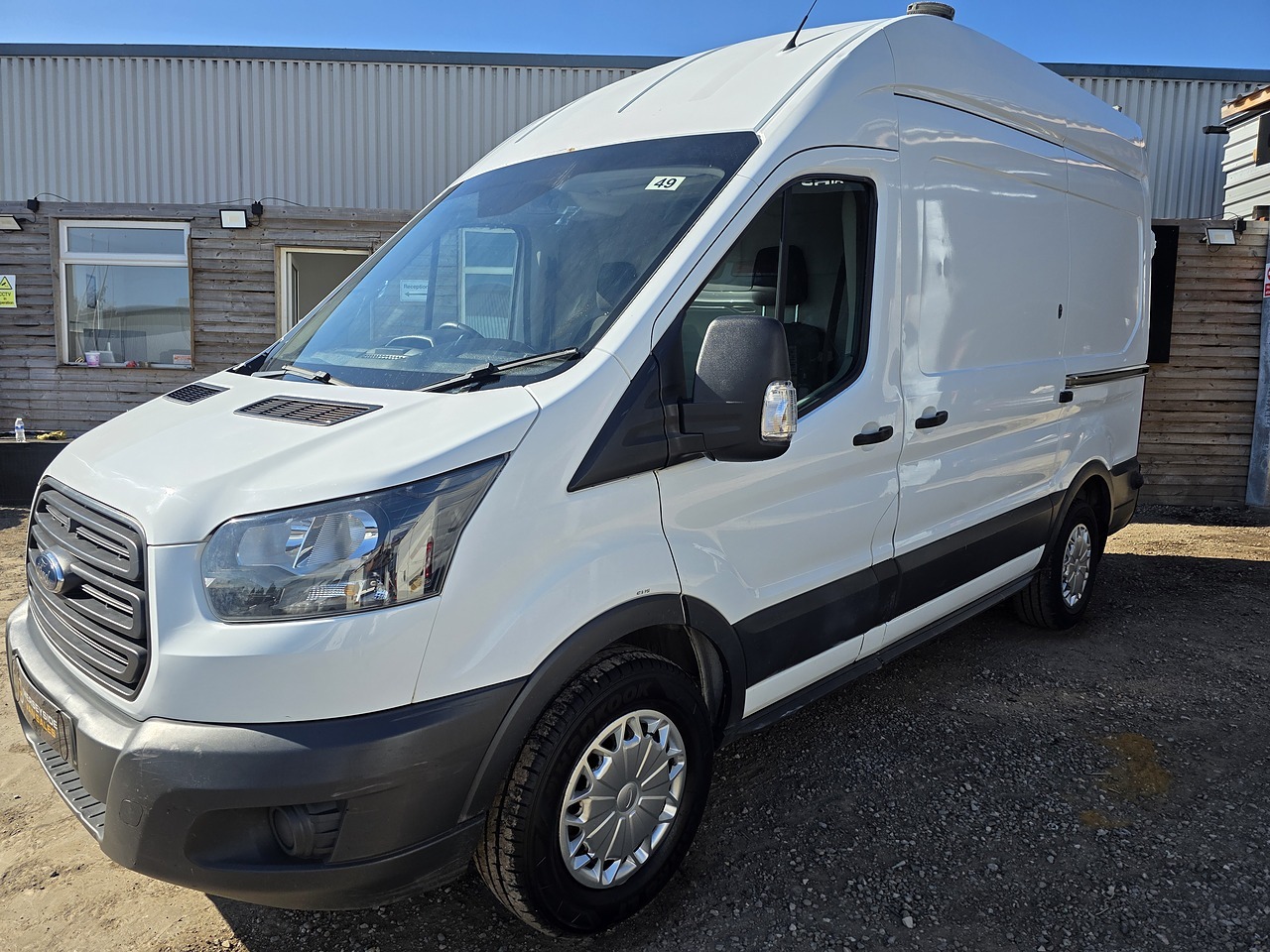 Ford Transit high-roof panel van parked beside our sales office
