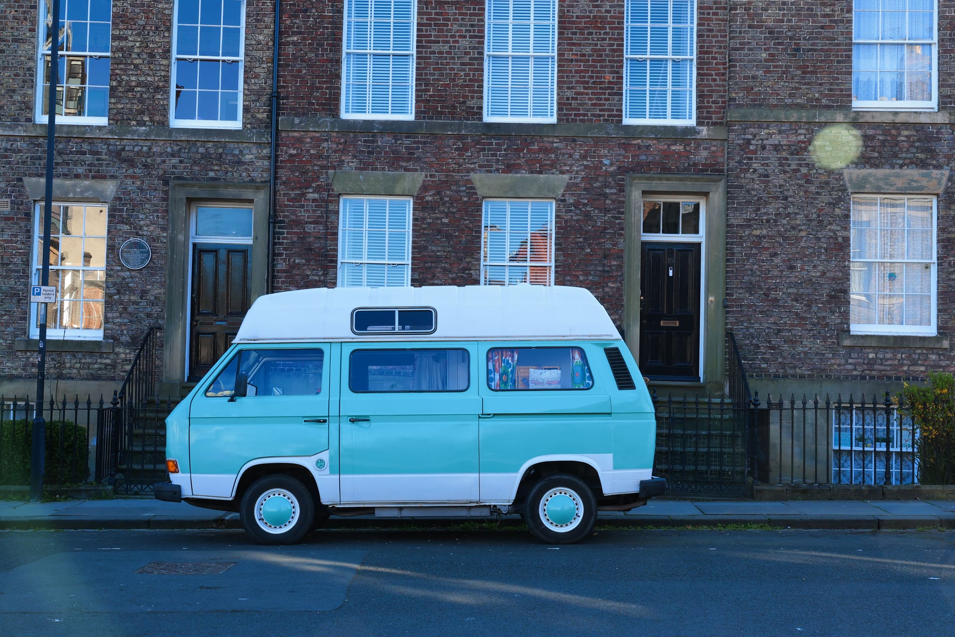 A classic vintage camper van parked on a residential street in Newcastle upon Tyne, England.